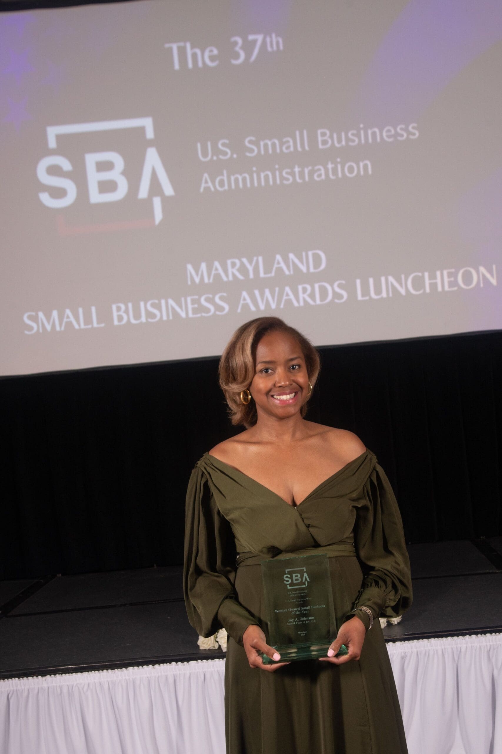 Joy Johnson holding an Award